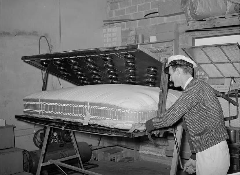 Historical photo of a worker making a mattress